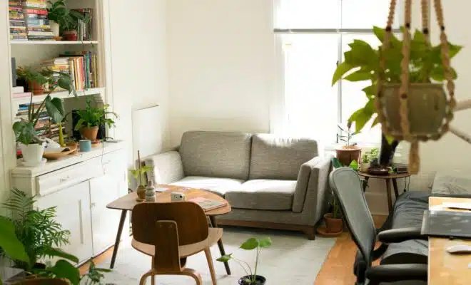 gray fabric loveseat near brown wooden table