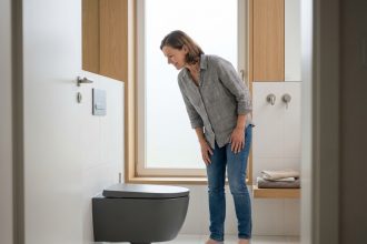 Femme admire un toilette moderne dans une salle de bain élégante
